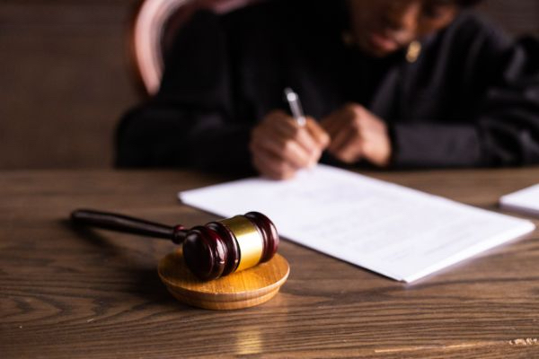 judge signing on the papers in court