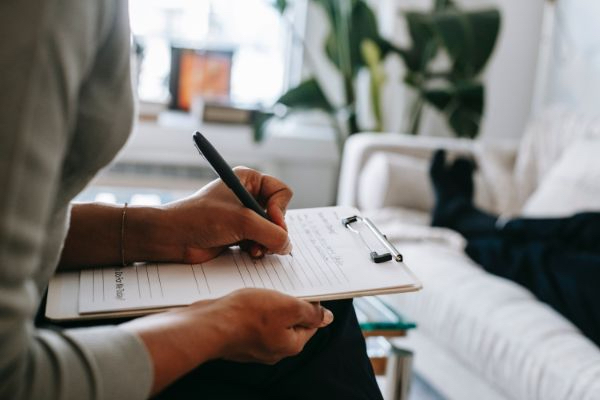therapist writing on a clipboard during a session