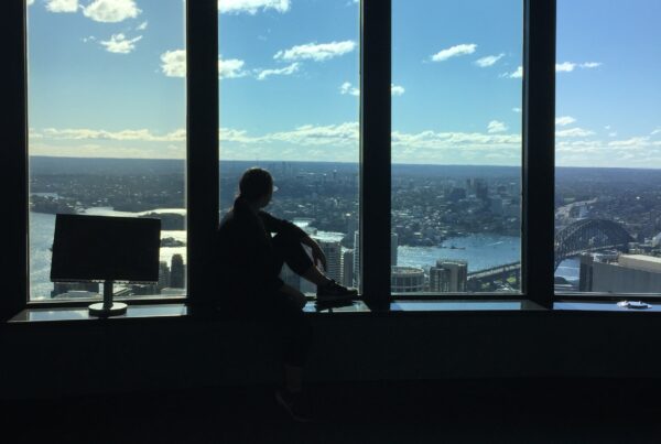 An intern sitting by the window looking into the Sydney, Australia cityscape.