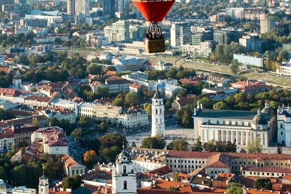 aerial shot of buildings and landscapes in Lithuania in Europe with a flying hot air balloon
