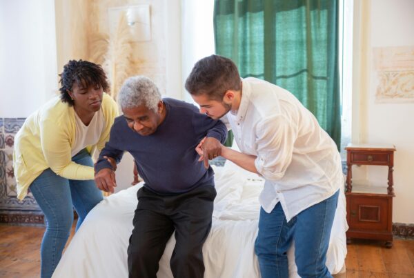 An intern helping out a health worker assist a patient.