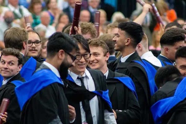 intext image 0007 A group of students on graduation day celebrate together.