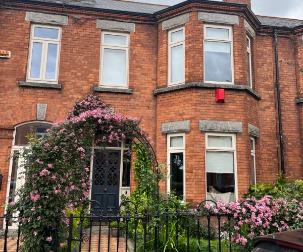host family home in Dublin, Ireland made of brick with a lovely gate covered in flowers, World Endeavors Select Internship Cohort in Dublin