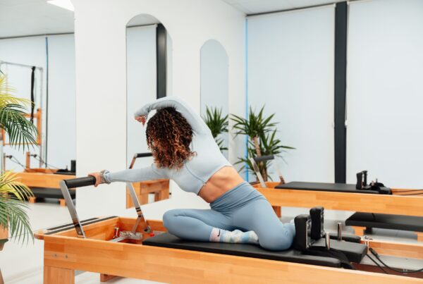 woman doing pilates on a reformer