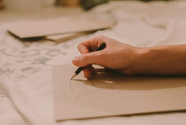 hand writing with pencil on paper