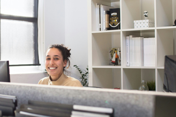 A woman sitting behind a desk.