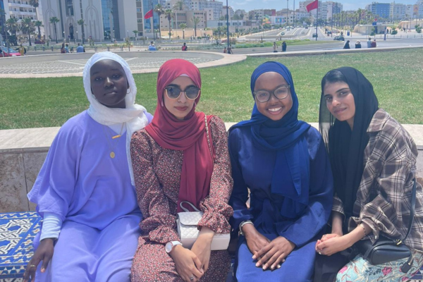 Four women sitting on a bench in Morocco.