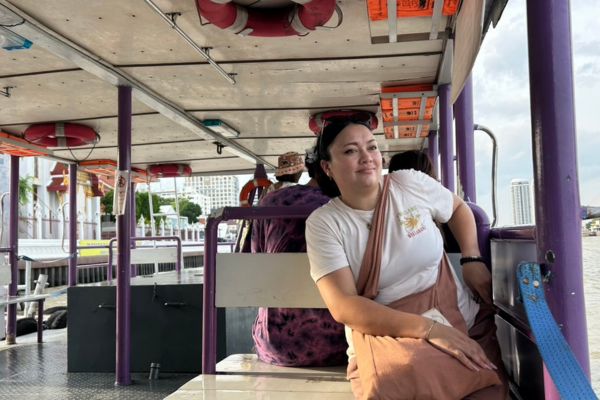 An intern sitting on a boat in Thailand.